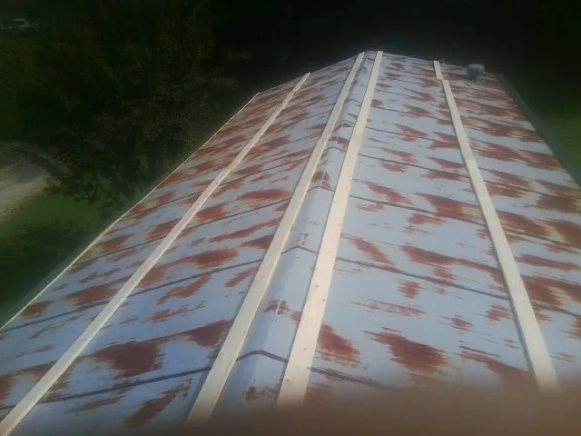 Rusted metal roof panels with new wood purlins before replacement — Storm Damage Roof Repair in Notre Dame by Roofing Brothers